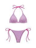 Pink bikini set with tie straps on a light gray background